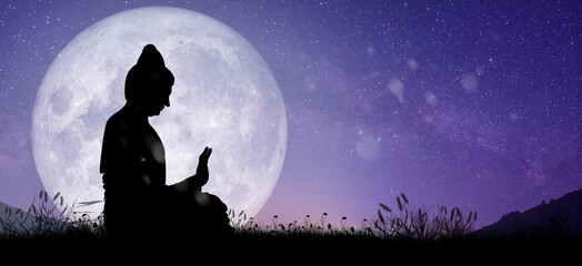Silhouette of Buddha mediating with Full moon at night. Buddhist holiday Concept.