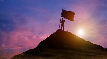 Silhouette businessman with flag climbed to the top of mountain over the sky and sun light background. Success, Achieving goal, Leadership, and Business achievement Concept.