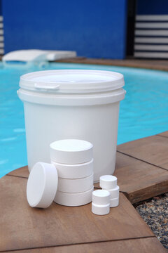 White chlorine tablets for swimming pool disinfection, pool water maintenance.	