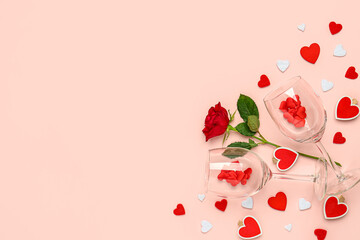 Composition with wine glasses and rose flower for Valentine's day on pink background