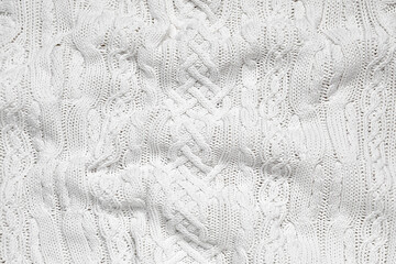Texture of stylish knitted fabric with folds as background
