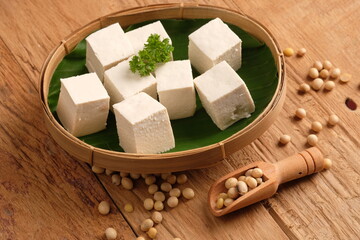 tofu or bean curd is traditional food made from soybean. sliced tofu on bamboo woven container with...