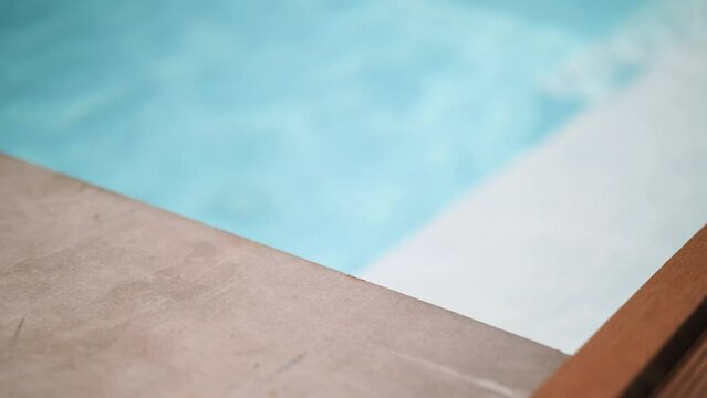 Detail of teca wood on a luxury swimming pool in summer on travelling