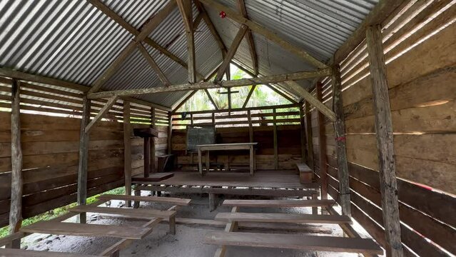 Pan right interior view of a simple wooden Christian church in the village of Masoala, Madagascar.