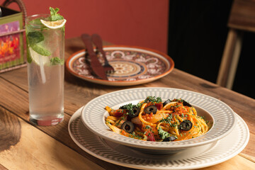 italian pasta next to a drink