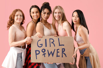 Beautiful young happy women holding paper with text GIRL POWER on pink background. Women history...