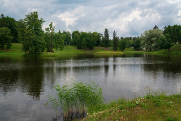 Fototapeta na wymiar View of the Karpiev Pond in the Oranienbaum Palace and Park ensemble on a summer day, Lomonosov, St. Petersburg, Russia