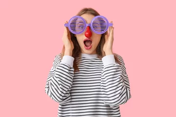 Fotobehang Beautiful young shocked woman in funny disguise on pink background. April Fools Day celebration © Pixel-Shot