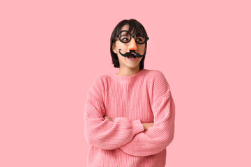 Beautiful young shocked woman in funny disguise on pink background. April Fools Day celebration - obrazy, fototapety, plakaty