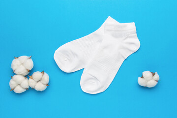 Cotton buds and a pair of white socks on a blue background.