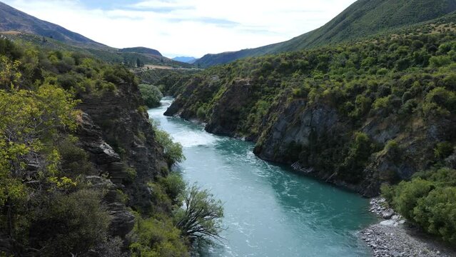 Kawaraw river flows between mountains at Roaring Meg, beatuful shot, Queenstown, New Zealand