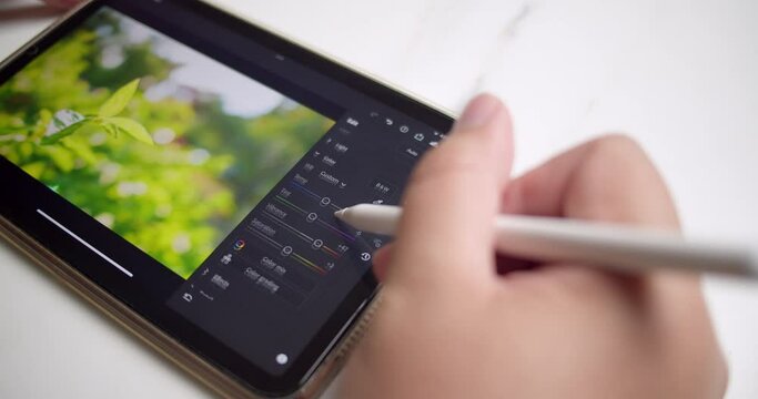 Editing some images using a computer software using a portable electronic gadget and a digital stylus pen.