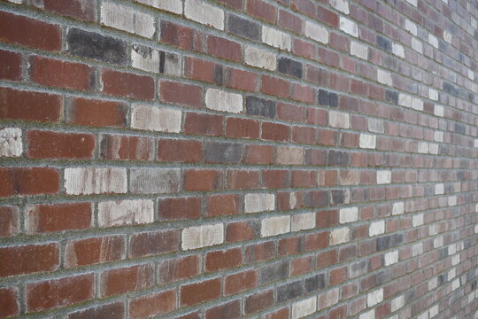 Mixed colored brick wall, angled shot.