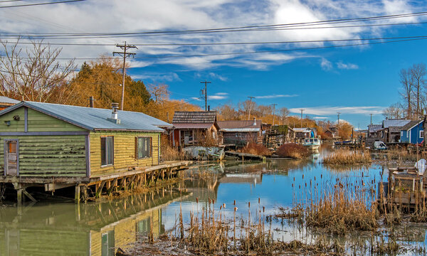 Finn Slough Panorama. Motorbot at Fishermen Village.  The historic fishing settlement of Finn Slough on the banks of the Fraser River in Richmond, British Columbia, Canada