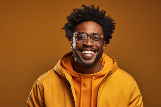 African American man smiling in yellow background studio