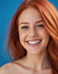 Obraz premium naked body of a girl with a wide smile with veins and red hair on a blue background, toned athletic body