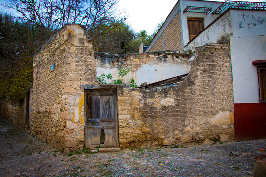 Faded facade of an old house located on a corner of an old 17th-century cowboy town in the city of San Luis Potos&iacute;, Mexico.