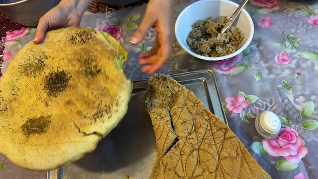 Pink color food persian cuisine local people life in countryside traditional cooking method in Iran sheep milk dairy base food serve with eggplant tomato healthy dish soak local bread in the bowl Iran