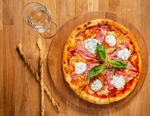 pizza with mozzarella on wooden background