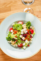 greek salad on the wooden background