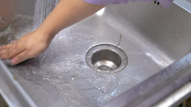Hand of woman cleaning sink 
