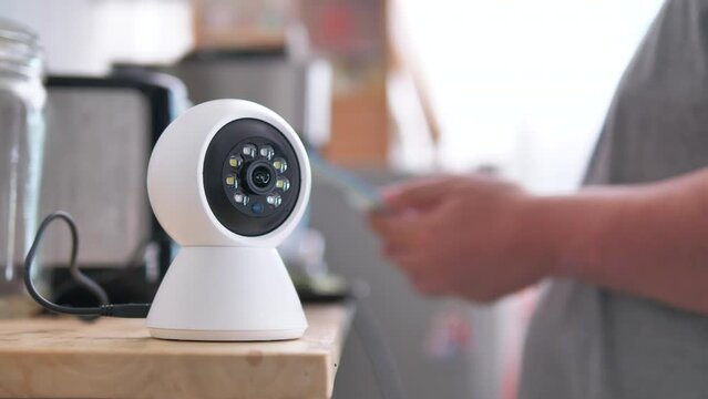 The people use smartphone to control ip camera works by panning and scan for detect. Home security and protection concept