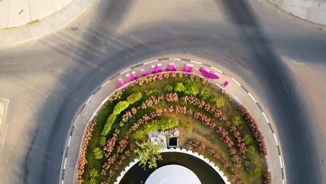 Aerial tilt-up view from fountain of arch 22 entrance of Banjul city, Gambia with I love Banjul letters