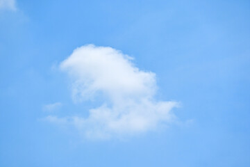 beautiful blue sky and white fluffy single cloud with sunrise in the morning, natural background