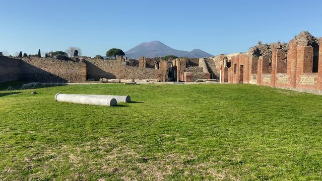 Old sanctuary in Pompeii with Vesuvius volcano in background.