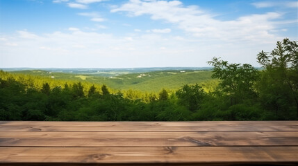 Empty wooden table top in front of green mountain and blue sky at summer blurred background.