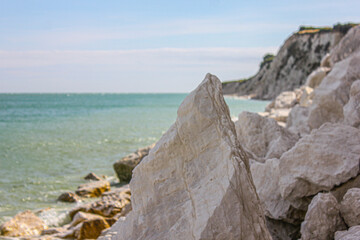 Fototapeta na wymiar rocky coast by the sea or ocean, beautiful sunny weather, relaxation, travel, holidays 