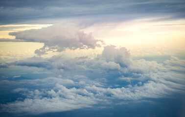 Sky above clouds with dramatic light. High nature view clouds on sky background. Cabin view from airplane. 