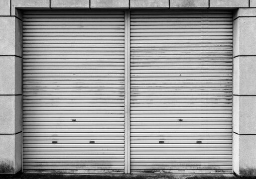 Closed steel shutter door of warehouse, storage or storefront for metal door background and textured.