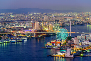 Fototapeta premium Osaka city skyline aerial twilight view of Osaka bay area with the ferris wheel. Japan architecture landscape background.