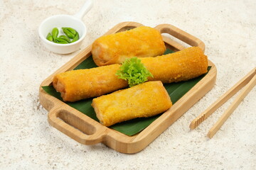 Fried Risoles or Risol is a Typical Indonesian Traditional Street Food . Served with green chili on white background