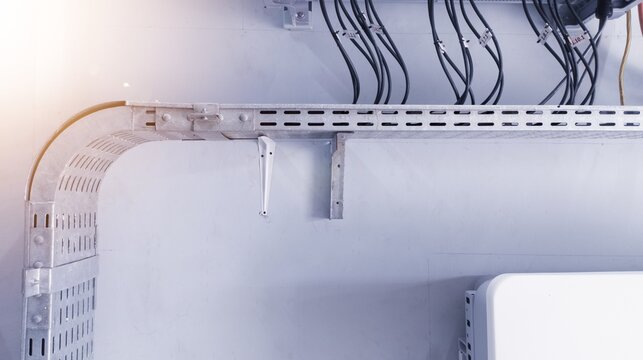 Installation metal cable tray on the wall of power control room.