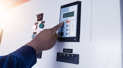 The Technician setting the parameter of the Over Current Rellay on control cubicle panel.