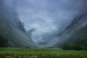 Beautiful clouds between the mountains that make the Stardalselva Valley near Klakegg, Norway