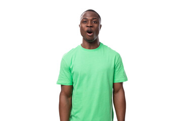 portrait of young surprised handsome american man in green t-shirt and jeans