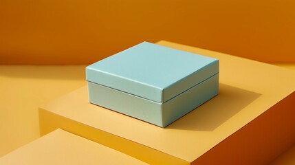 A delicate powder blue square folding gift box, completely closed, on a rich amber background.