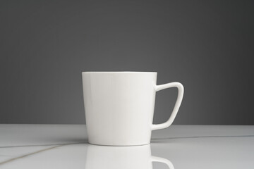 Ceramic mug on marble table on gray background