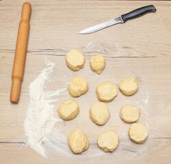 Fototapeta na wymiar Pieces of dough on the table in flour