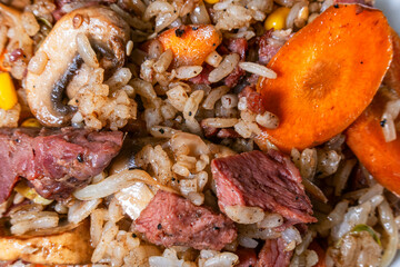 Freshly cooked Chinese fried rice with beef, carrot, alfalfa fetus and mushrooms