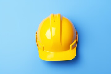 Fototapeta premium Yellow construction helmet on a blue background. The concept of Labor Day. Builder's Day. Copy space.