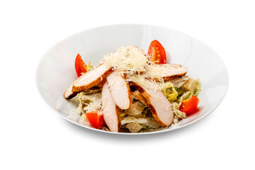 Caesar salad with chicken in a white plate. Isolated.