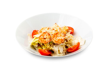 Caesar salad with shrimp in a white plate. Isolated.
