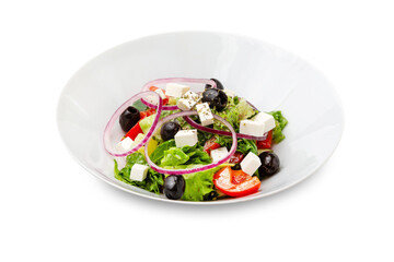 Greek salad in a white plate. Isolated.