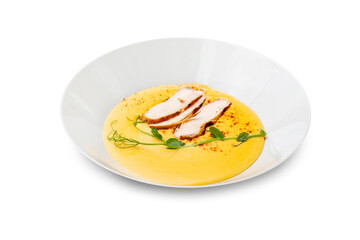 Cheese soup with chicken in a white plate. Isolated.