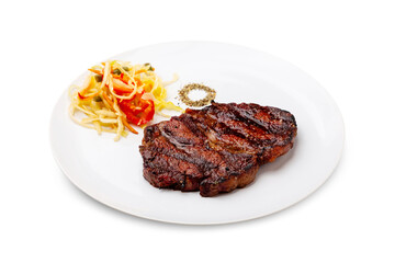Grilled beef ribeye steak in a white plate. Isolated.