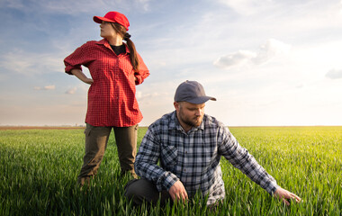 Young farmers in wheat field